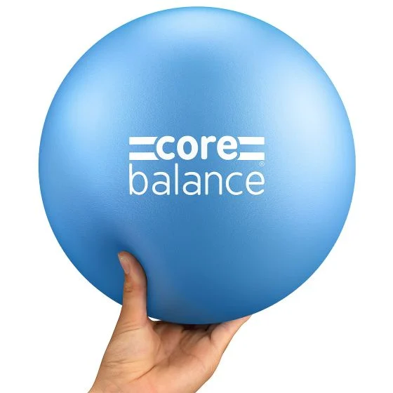 Blue Pilates ball with Core Balance branding being held.