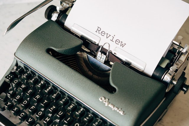 Type writer with the word Review printed.