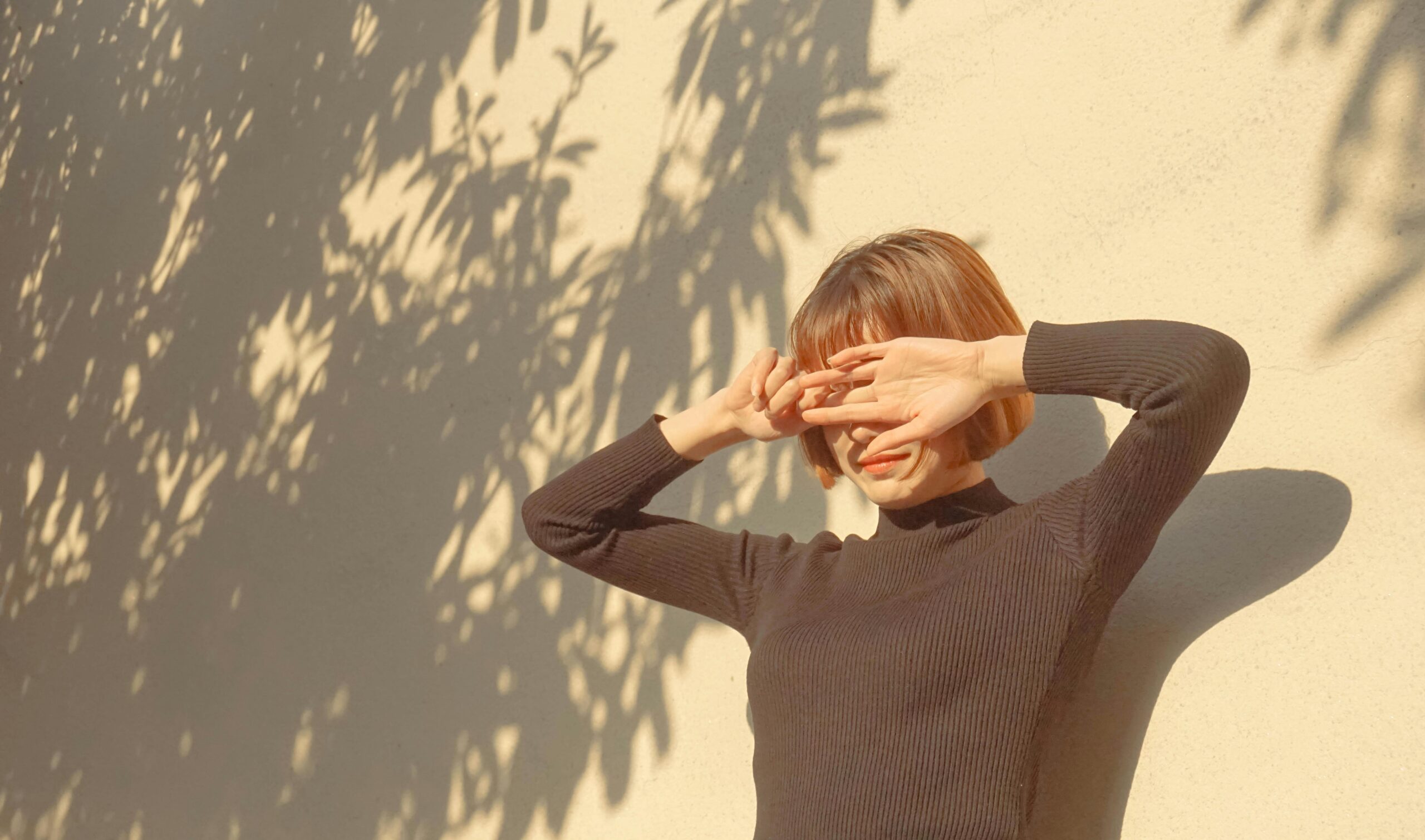 Hot weather affecting woman in black sweater.